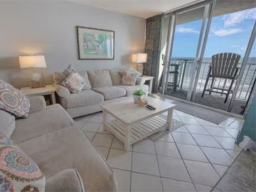 Comfortable living room with ocean views through large sliding glass doors
